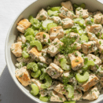 Healthy chicken salad with Greek yogurt, celery, and fresh herbs served in a bowl