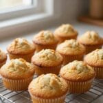 freshly baked simple moist muffins arranged on a cooling rack with golden tops and tender texture