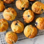 Simple moist muffin recipe with freshly baked golden muffins cooling on a wire rack.