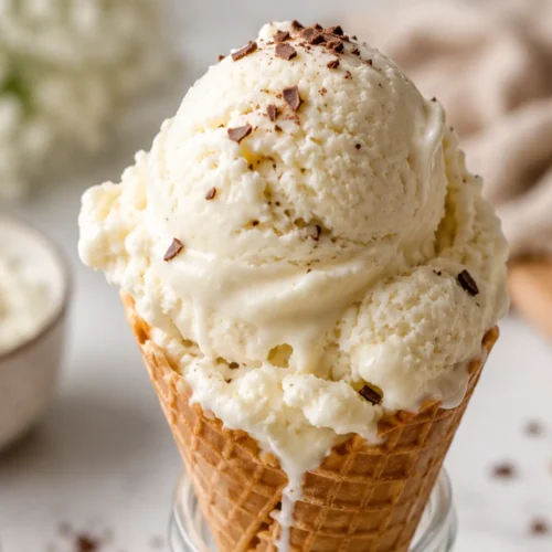 Keto cottage cheese ice cream in a waffle cone with creamy vanilla texture and chocolate shavings