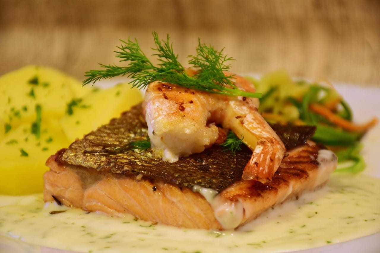 Close-up of baked honey garlic salmon fillet with sticky glaze and garnish