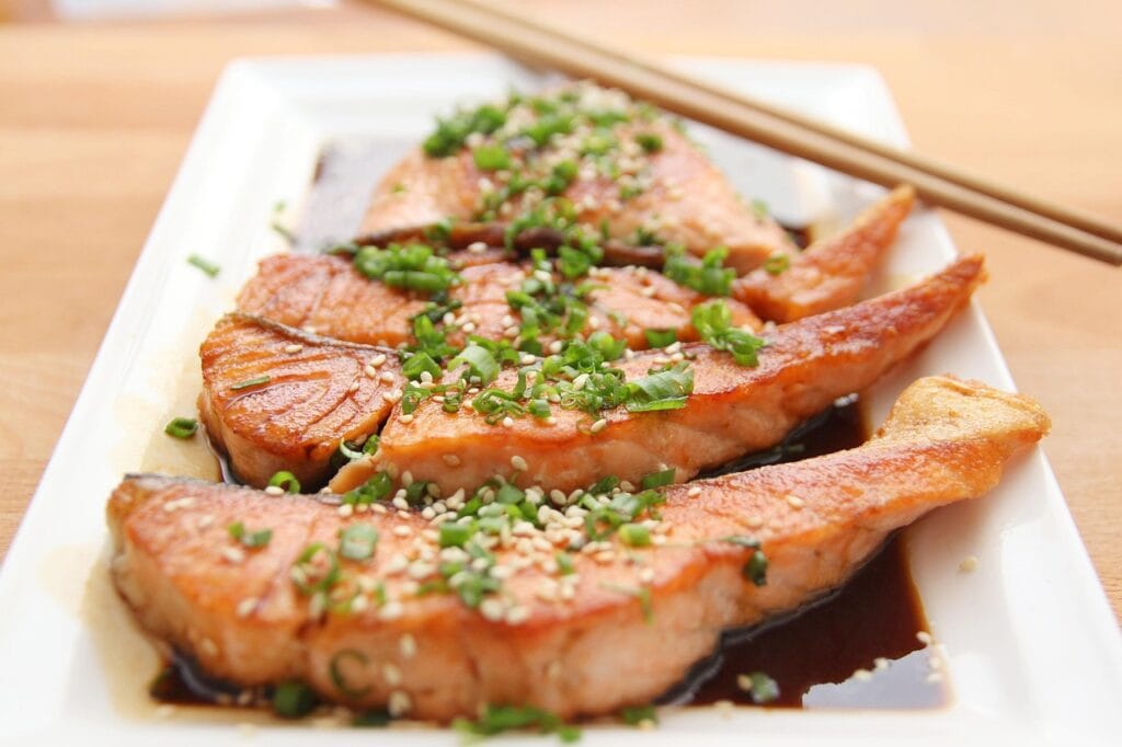 Glossy honey garlic glazed salmon fillet plated with a rich, sticky sauce