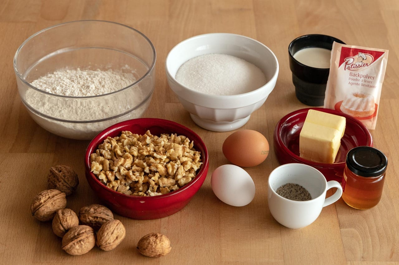Flat-lay of flour, eggs, and baking ingredients arranged before making a chocolate brownie cake