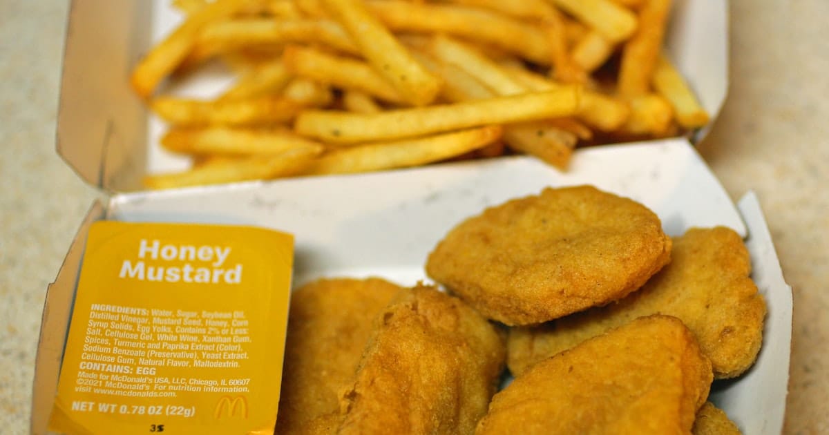 Fast-food-style chicken nuggets served alongside a portion of french fries